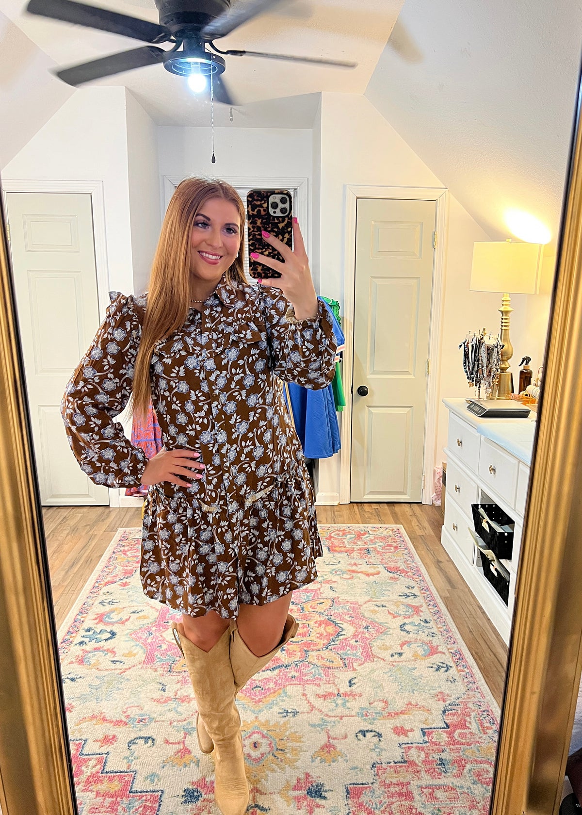 brown and blue floral dress with ruffles on the shoulder and buttons down the front