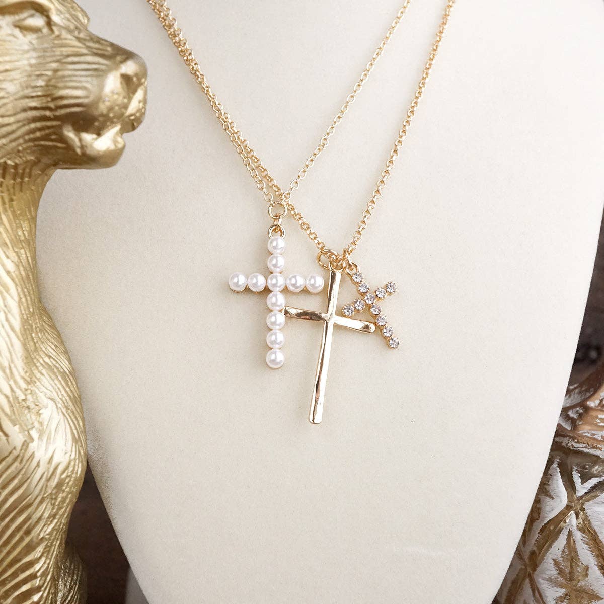 up close view of the sacred layers cross necklace