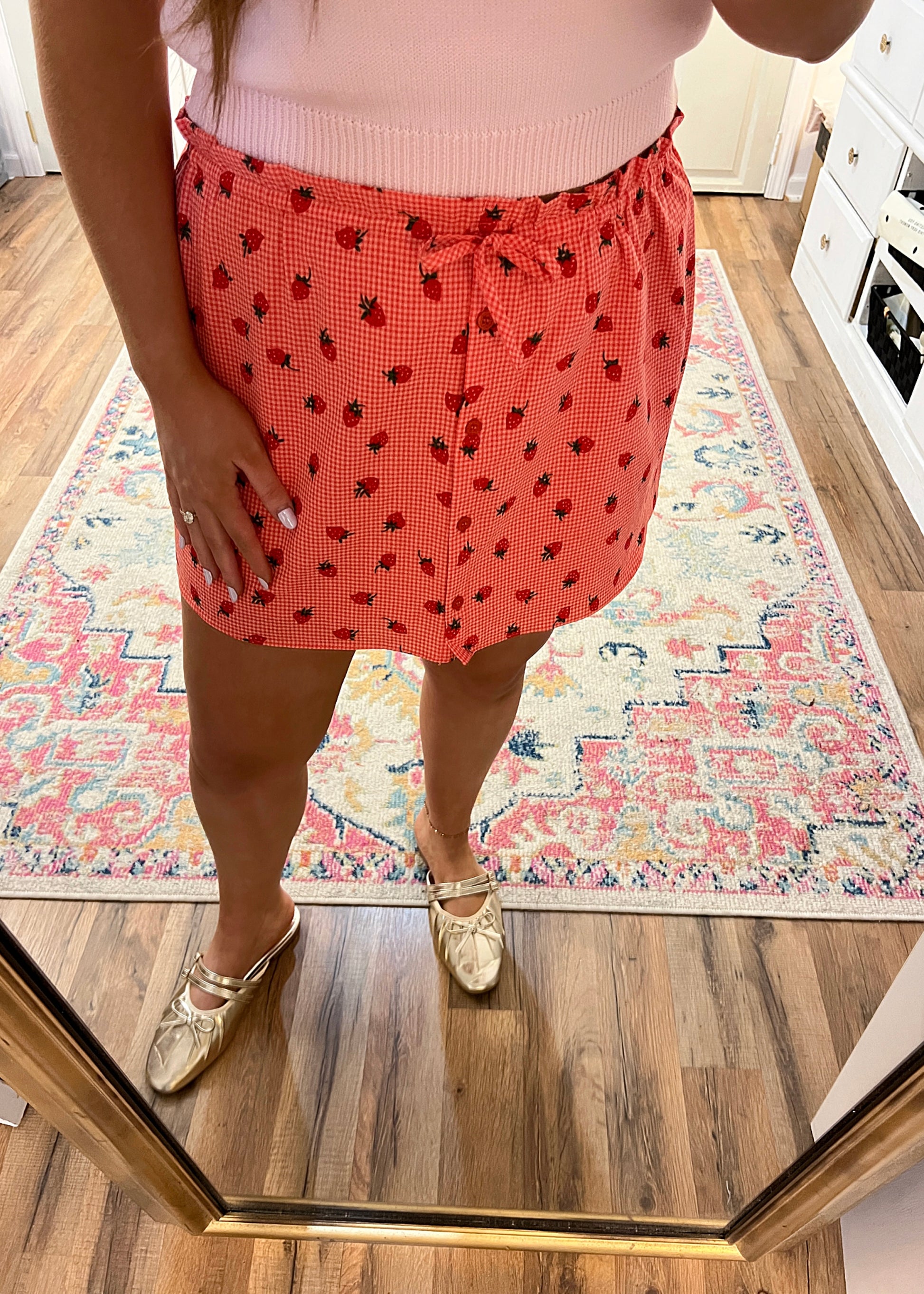 red gingham skirt with a strawberry pattern and buttons down the front