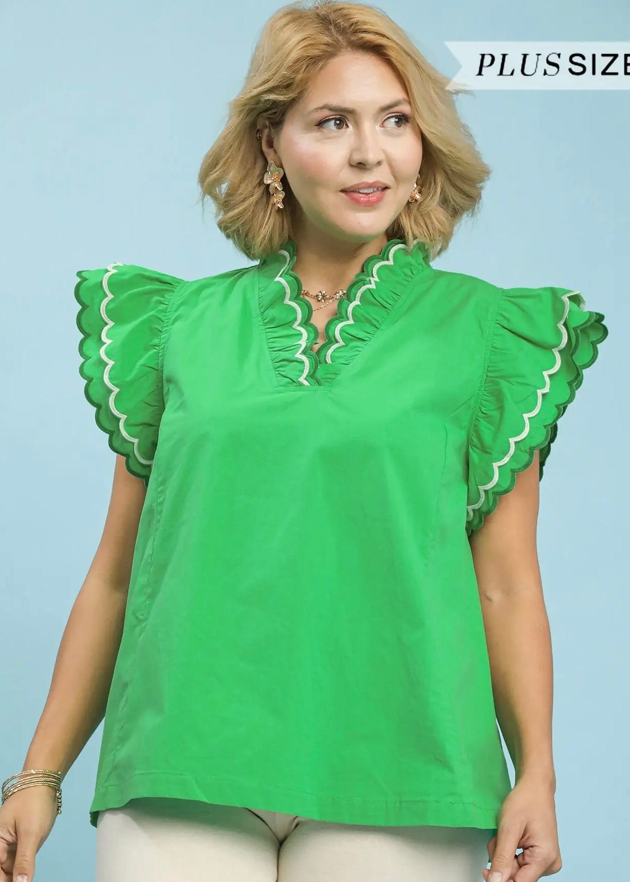 Green top with a ruffled collar and sleeves