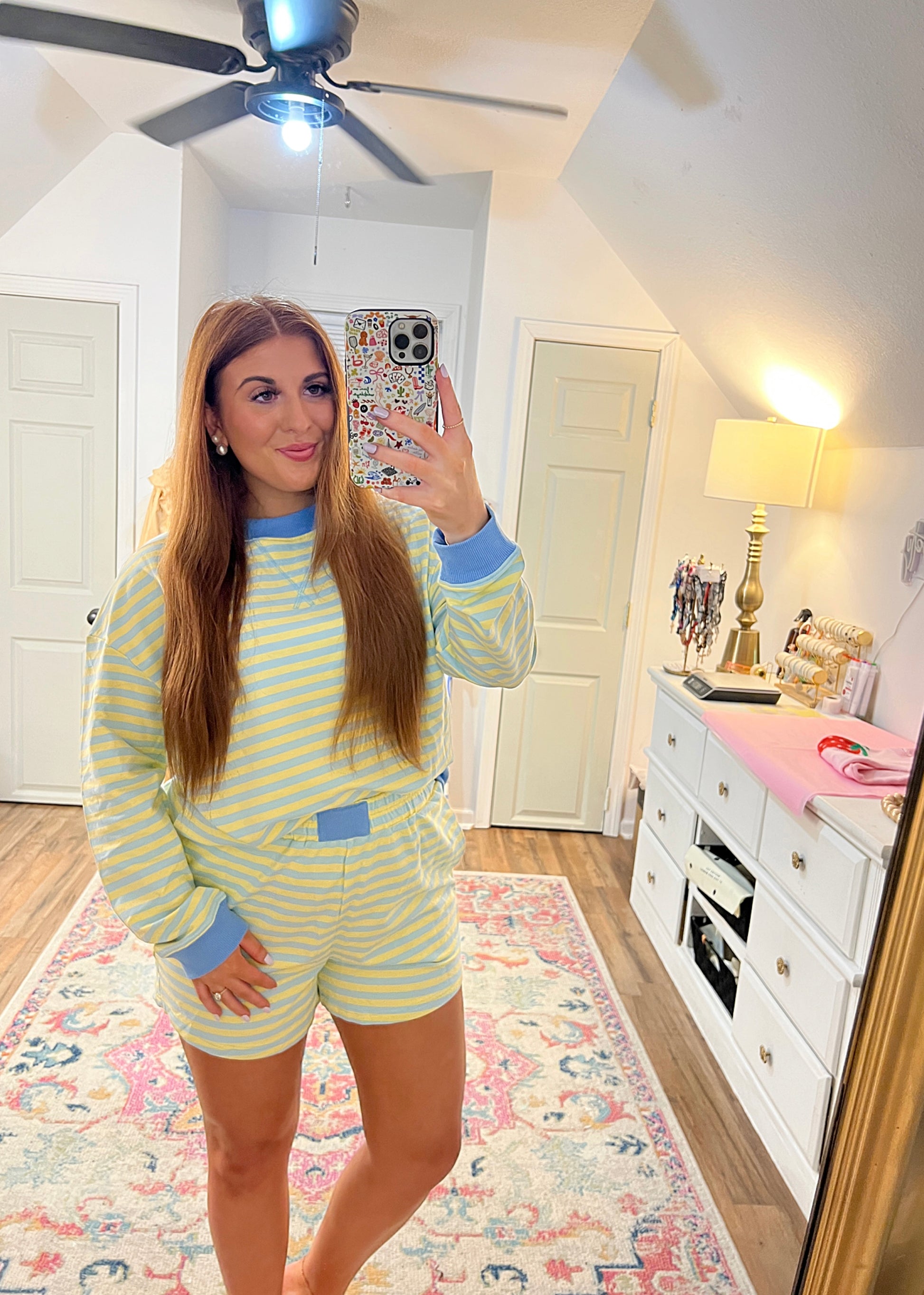yellow and blue striped long sleeve with shorts two-piece set with top tucked in 