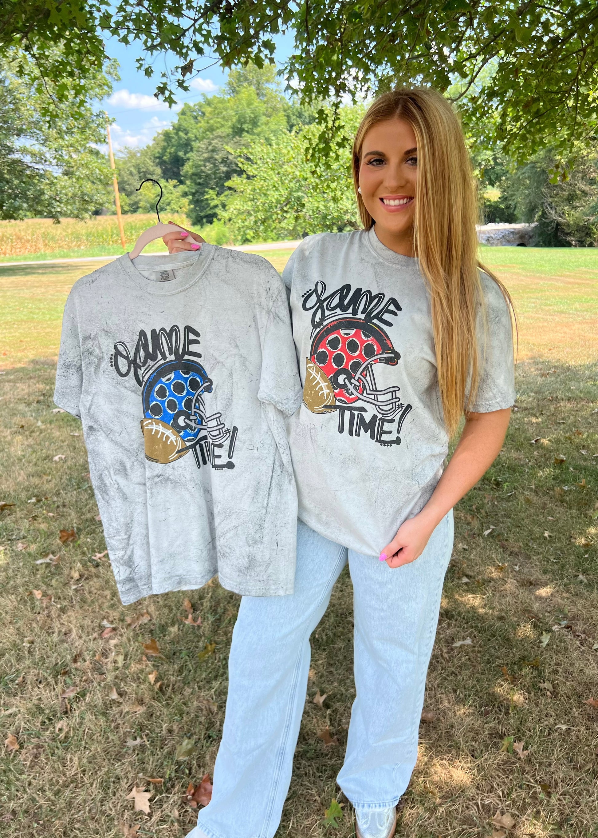 women’s game day graphic tee in blue or red football and helmet