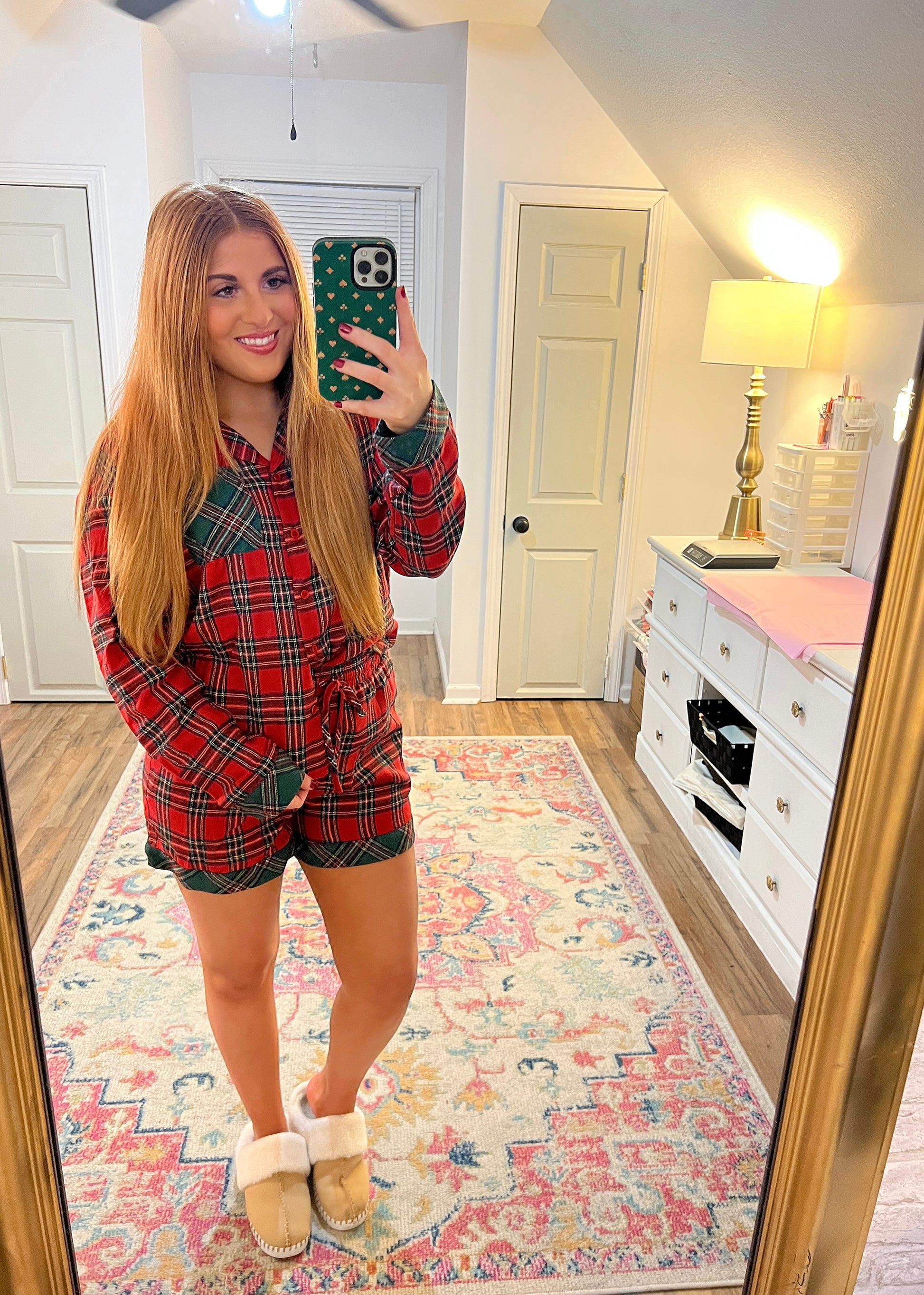 Women’s red, plaid, and green Home For The Holidays pajama set for Christmas.