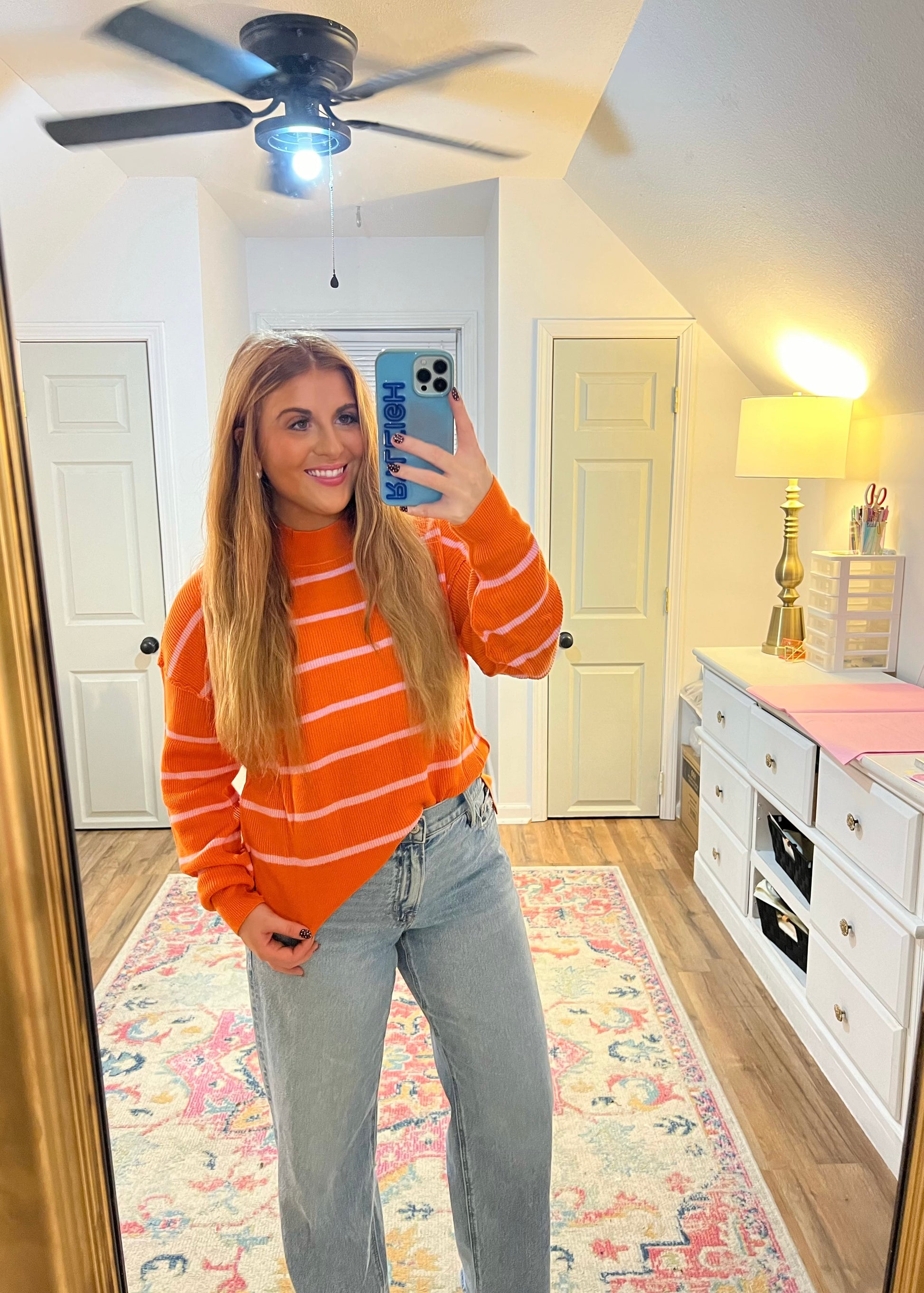 Orange and pink striped knit sweater with long sleeves