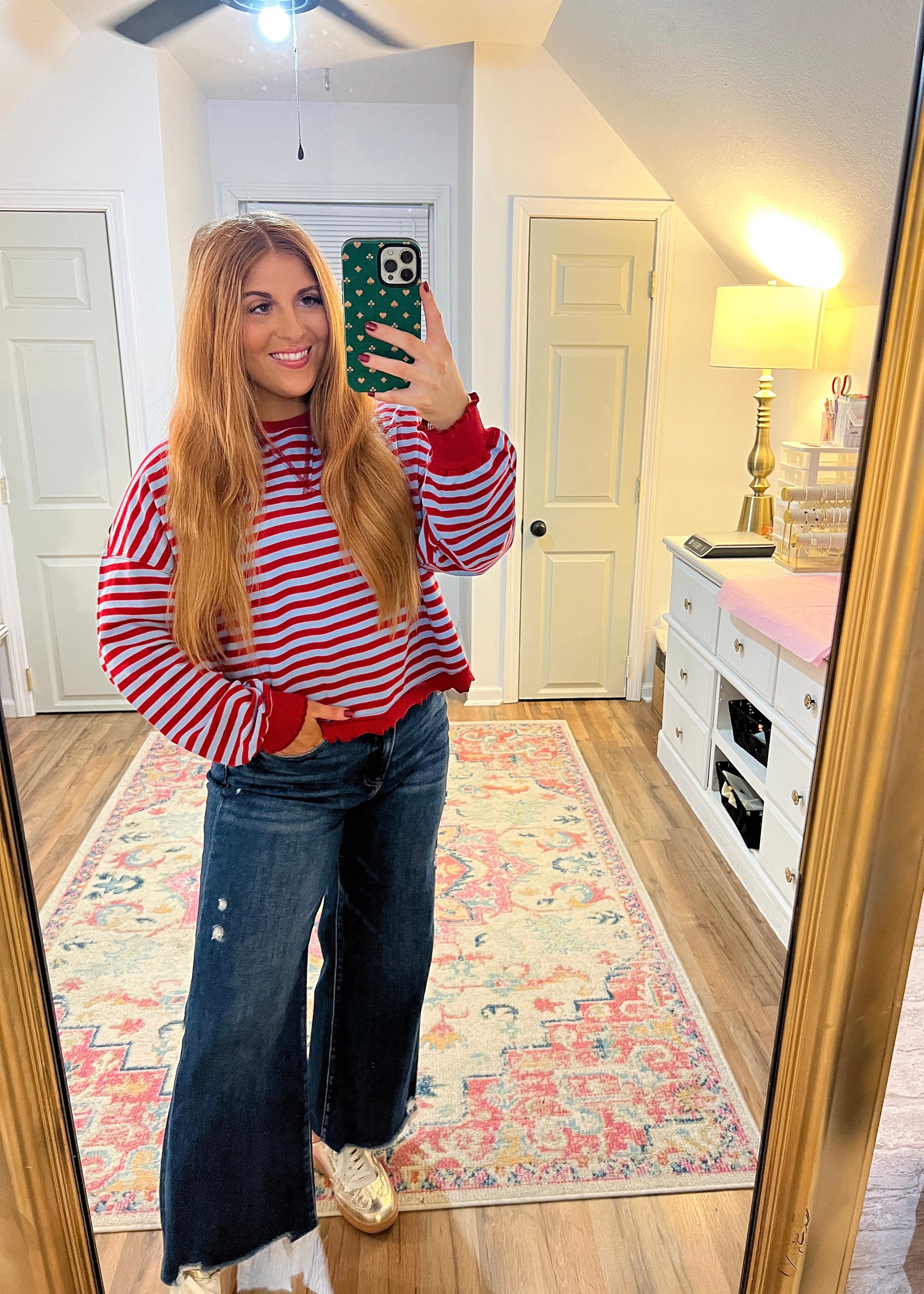 Women’s red and blue striped top featuring ruffled trim details